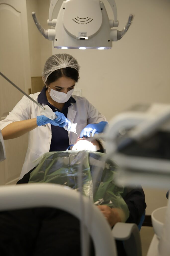 a person in a dentist chair with a mask on