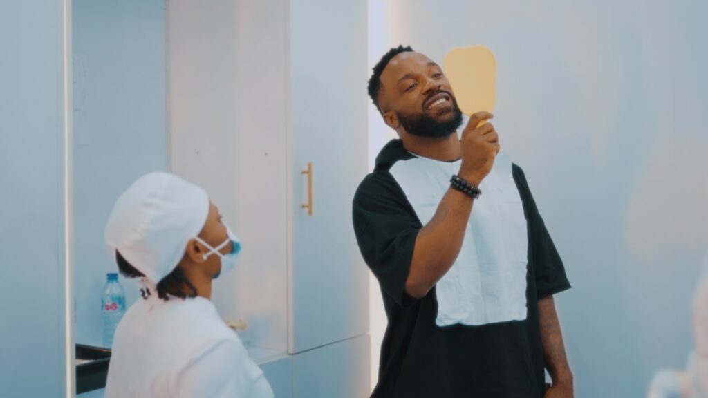 a man brushing his teeth in front of a mirror